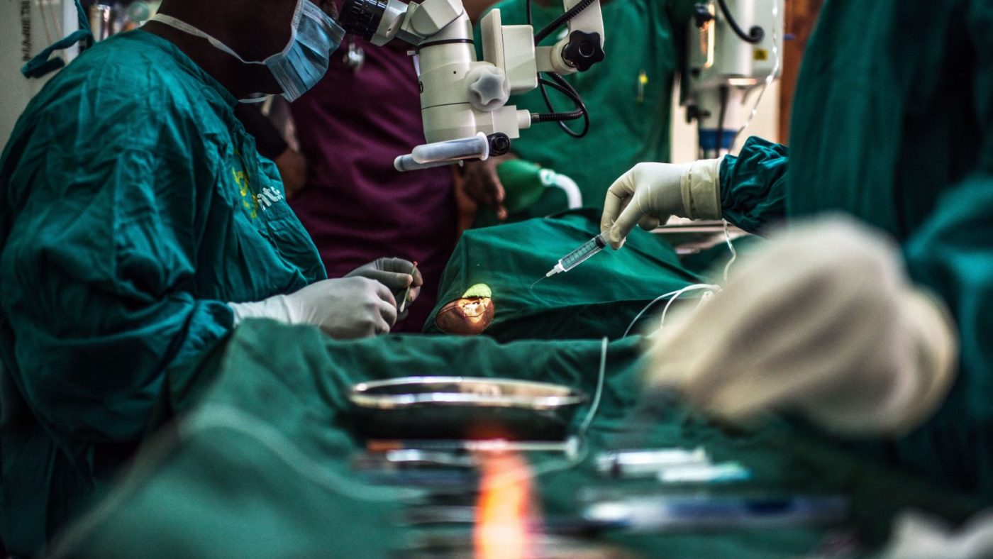 A hand sterilises surgical equipment.