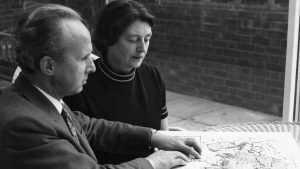 Sir John and Lady Wilson studying a braille map.