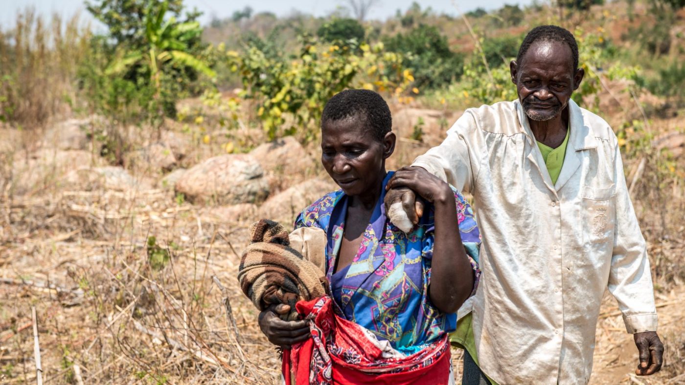 Winesi being led by his wife.