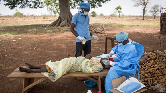 A lady has an eye operation outside.