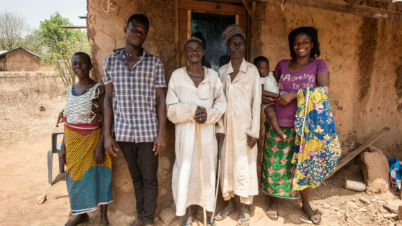 Mamodu's family are stood outside their house for a group photo.