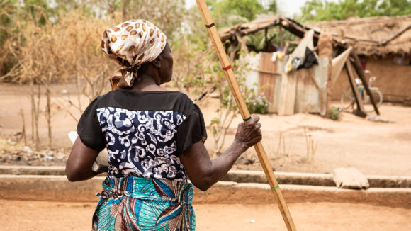 Mary stands with her back to the camera.