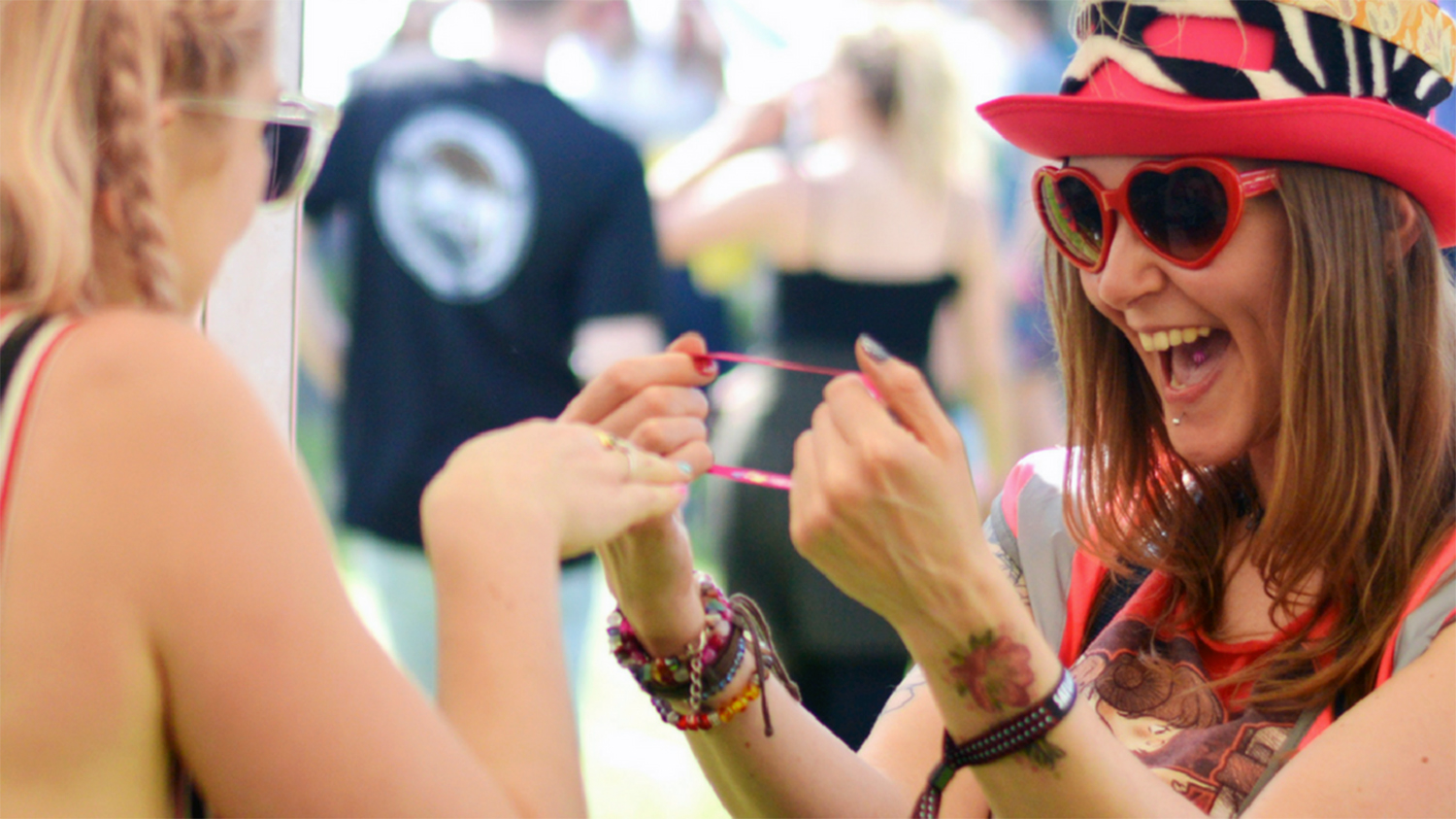 Two girls smiling at a festival.