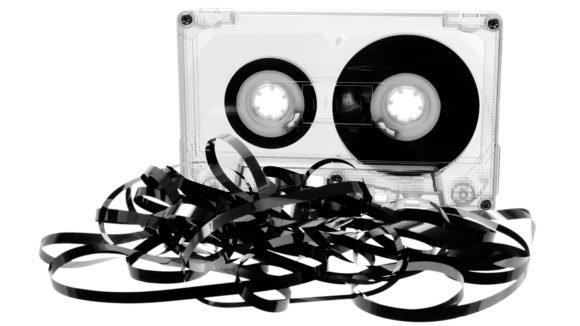 An old cassette tape with the magnetic tape unspooled.