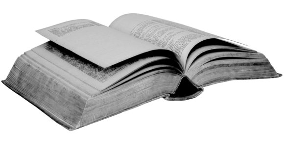 A think book lying open on a table.