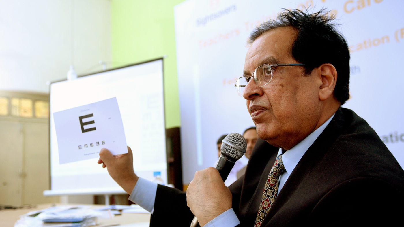 In Pakistan, a trainer shows teachers how to check their students' eyes.