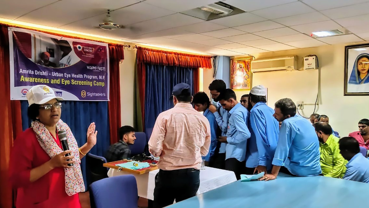 Men queue to have their eyes tested.