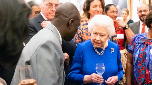 Samson Lokele talks to Queen Elizabeth at Buckingham Palace.