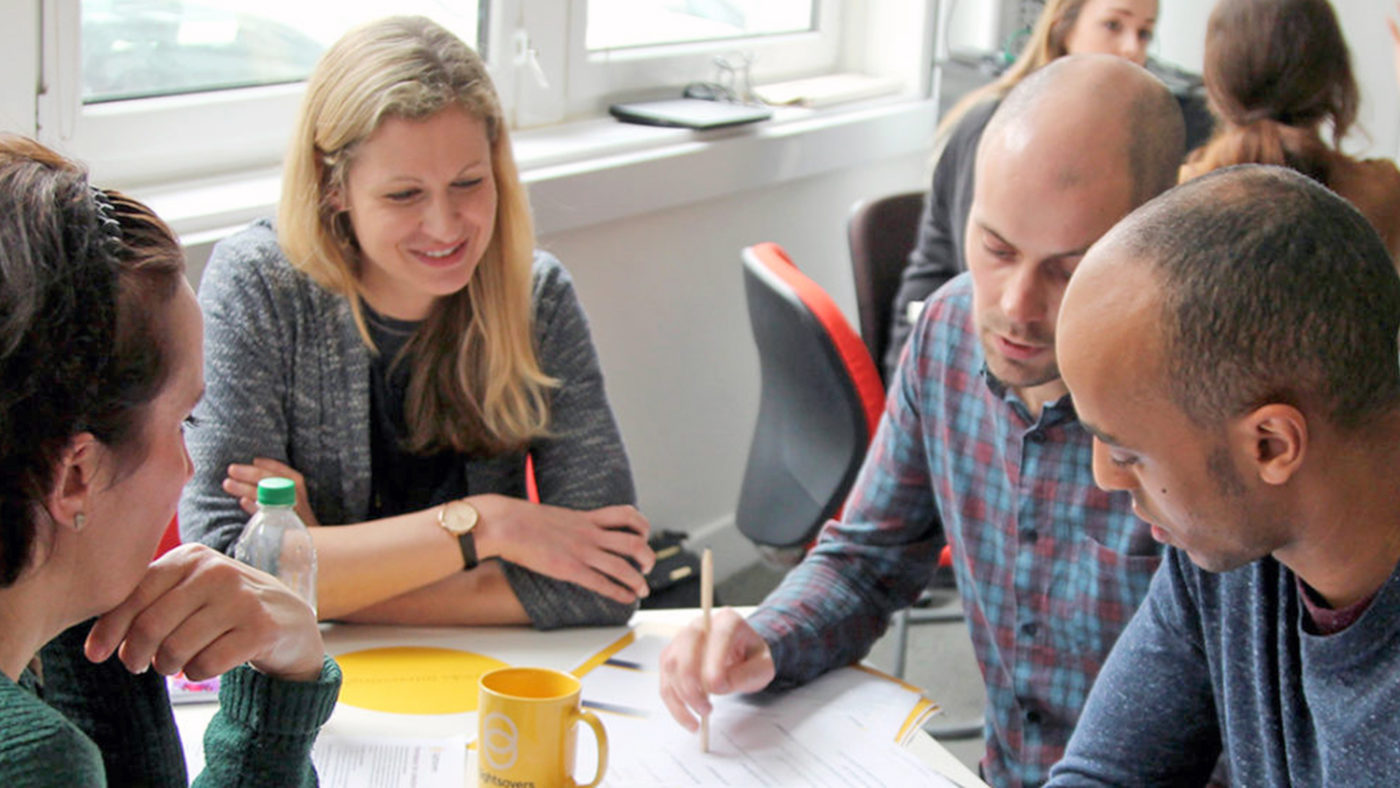 Helen chats to colleagues during a workshop session.
