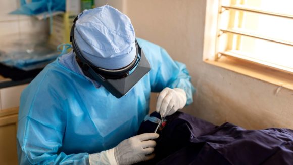 A surgeon performs trachoma surgery on a patient in Benin.