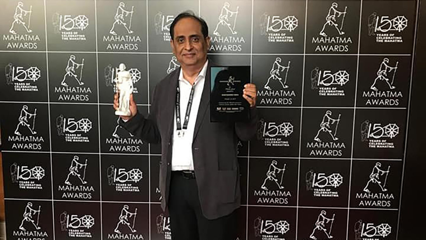 RN Mohanty holds up his award.