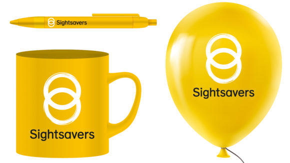 Examples of Sightsavers-branded items: a pen, a mug and a balloon, all yellow with the Sightsavers logo.