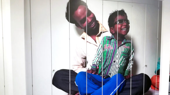 A photo of a man and his son on the front of some cupboards.