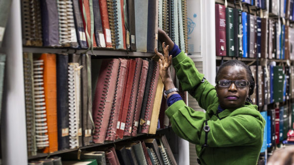 A women with visual impairment working in a library in Kenya.