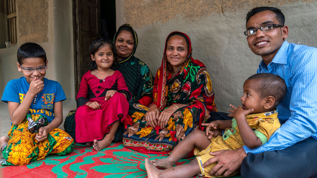 A family sitting outside.