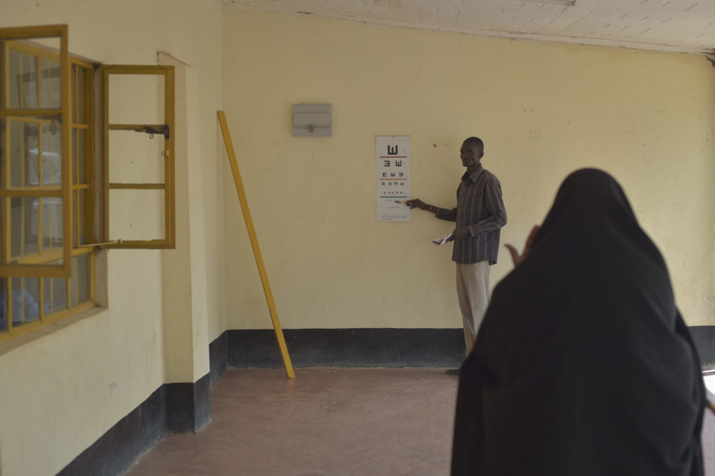 A man conducts an eye test.