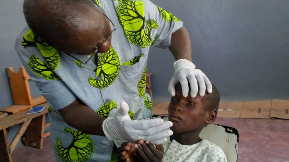 a young boy at an eye health screening in Cameroon.