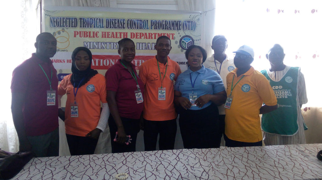 A group of people stand together for a photo