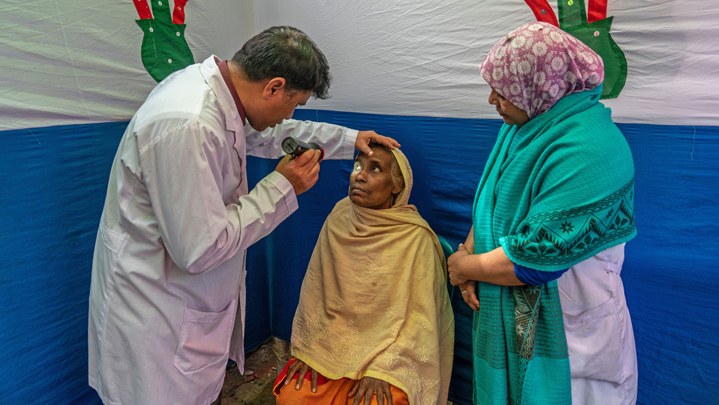 A woman having her eyes checked by a doctor.