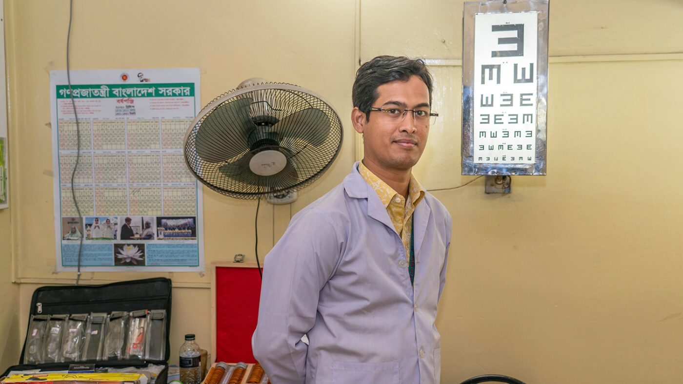 A man standing in an eye testing room.