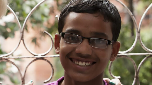 A teenage boy smiling.