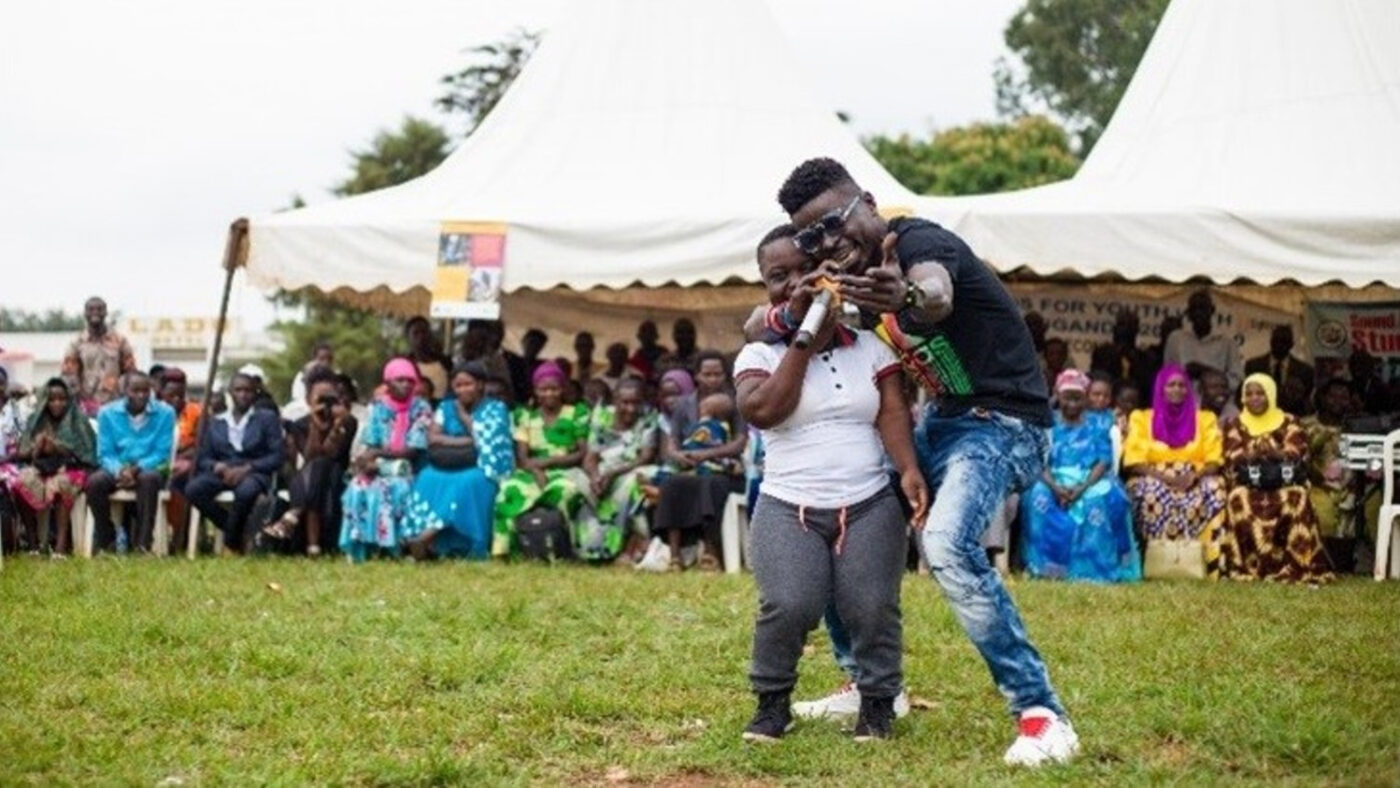 Two people performing outside at a careers fair.