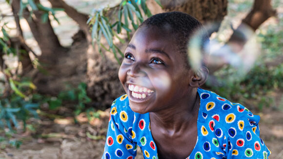Mary smiles as bubbles float round her head.