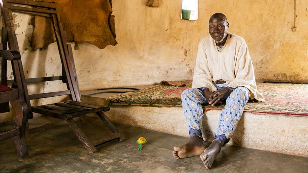 Sina sits inside a building.
