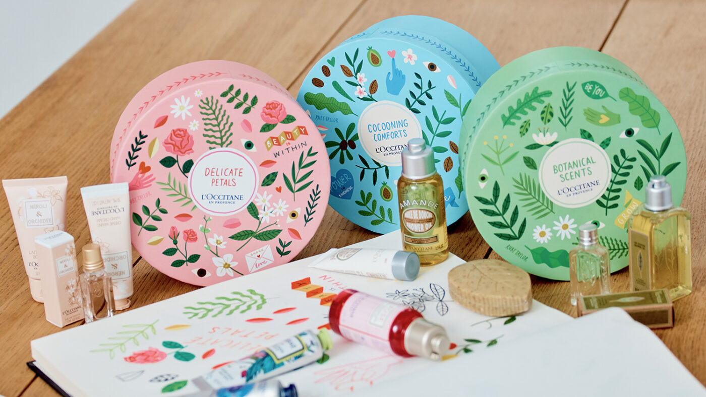 L'Occitane's 'Caring for Sight' gift boxes and products, displayed alongside a sketchbook with illustrations