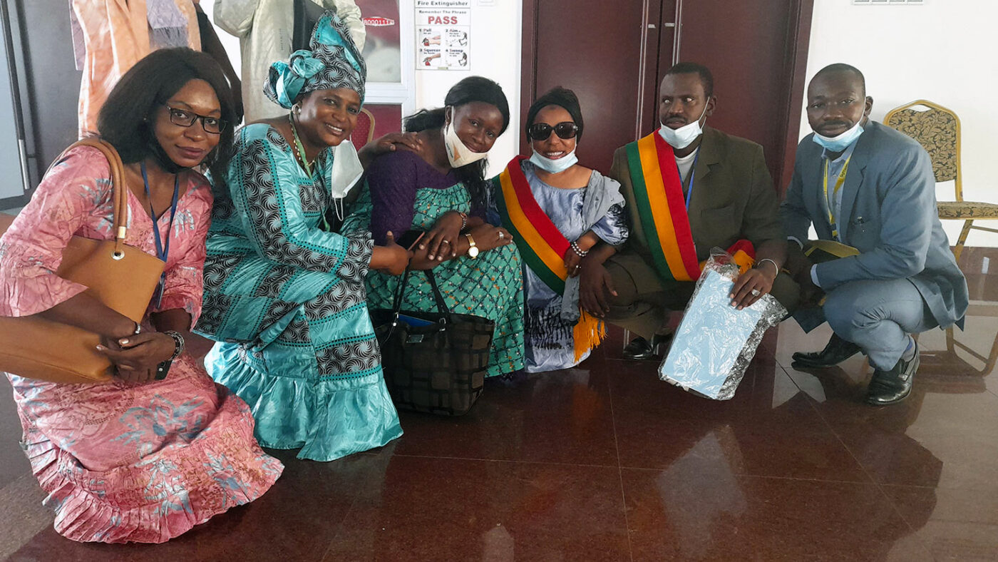 Five people, including the President of the Association des People of Small Size and the President of the Malian Union of the Blind, smile at the camera.