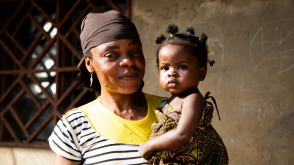 Bia from Cameroon holding her baby girl.