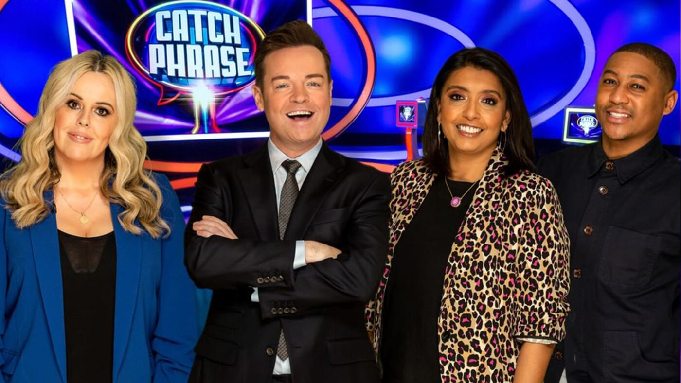 Roisin Conaty, Stephen Mulhern, Sunetra Sarker and Rickie Haywood-Williams smiling in the Catchphrase studio.