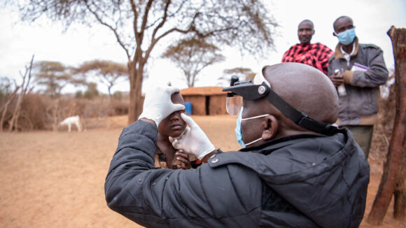 Maurice Abony checks Naomi's eyes for signs of trachoma
