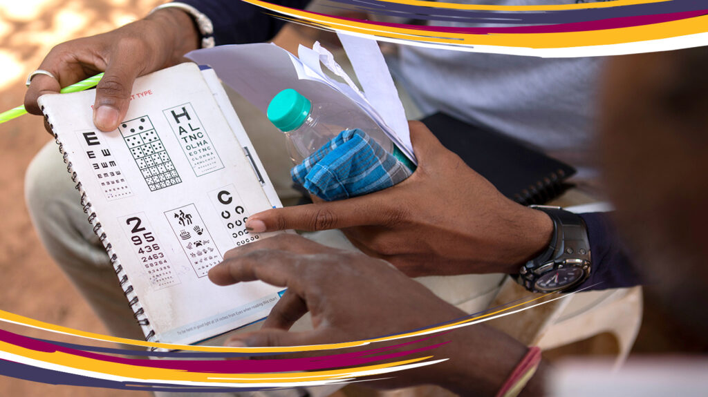 A close-up of a person's hands holding an eye test chart.