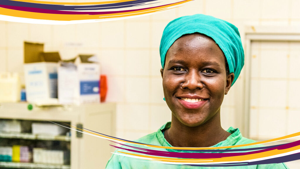 Gladys Atto in her doctor's uniform, smiling at the camera.