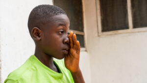 Arthur rubs his left eye with his left hand