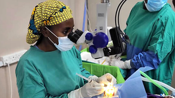 Ophthalmologist Moira performs an eye operation.