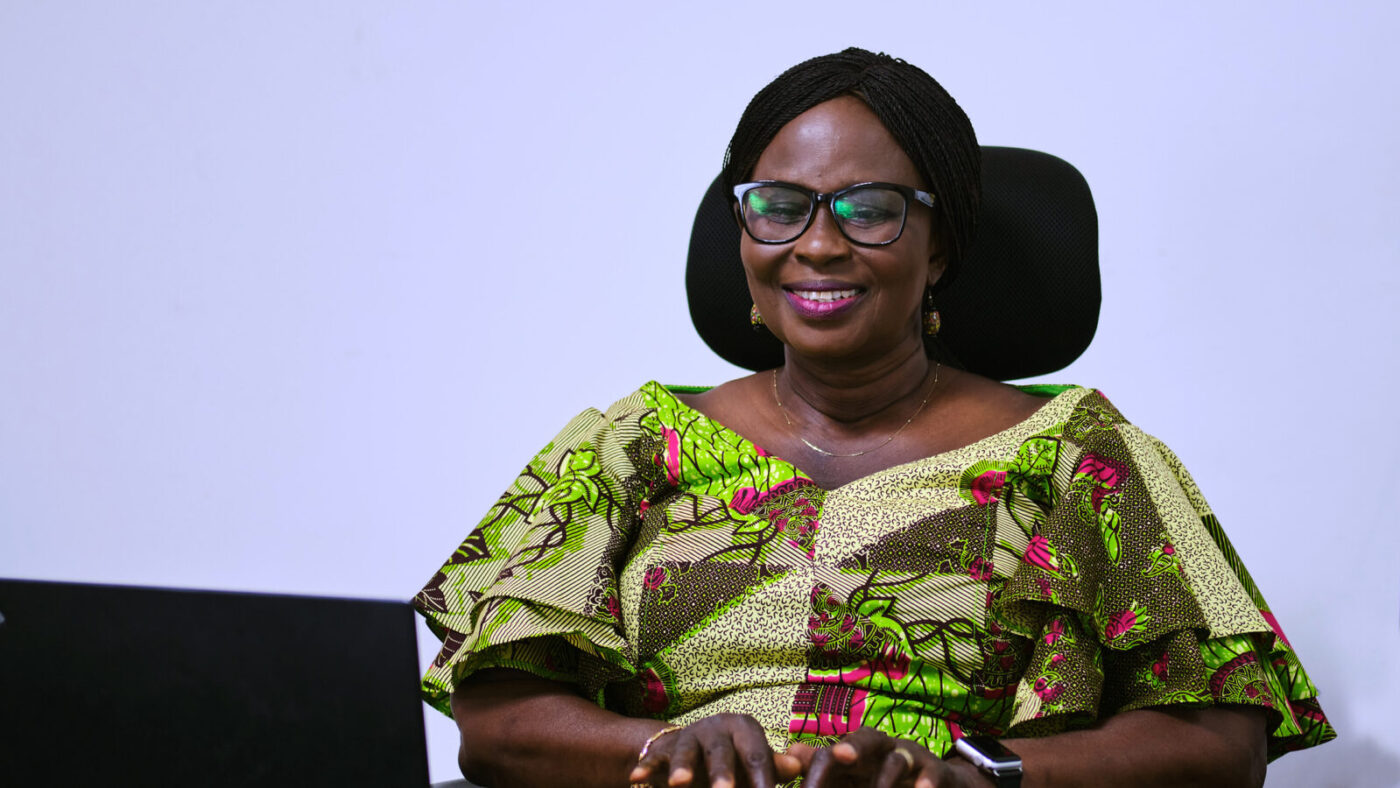 Gertrude Oforiwa Fefoame sits at her laptop.