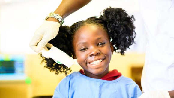 Luyando smiles as the doctor removes the bandage covering her right eye, following a cataract operation