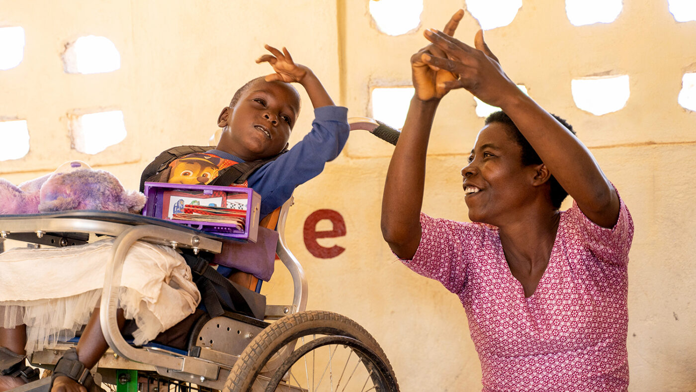 Nora teaching Glory, one of her students, how to count.