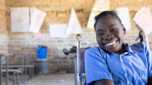 Grace, who uses a wheelchair, sits in her old primary school classroom.