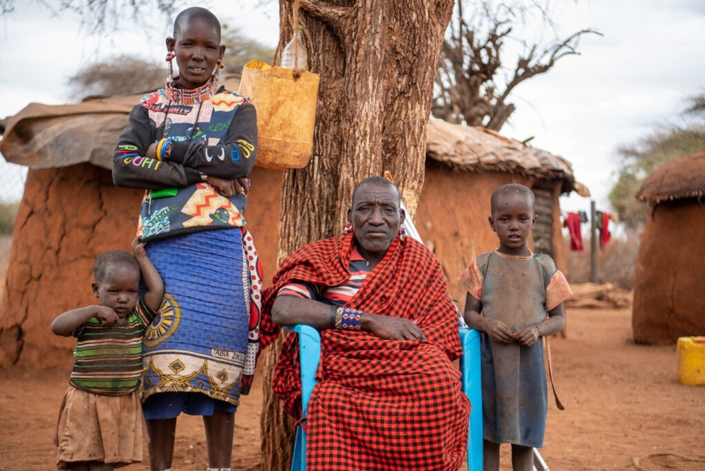 Lanoi (right), with her mum, Mesikana (standing), little sister, Teresian, and uncle, Sayianka, outside their home.