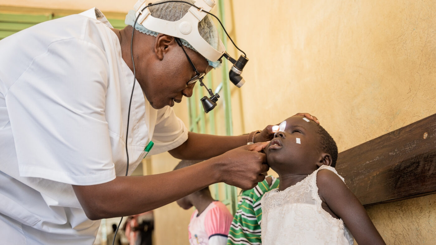 A health worker examines Happy's eyes.