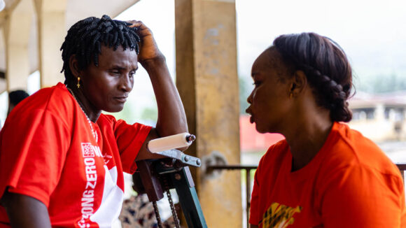 Two women talk at a sexual and reproductive health rights workshop.