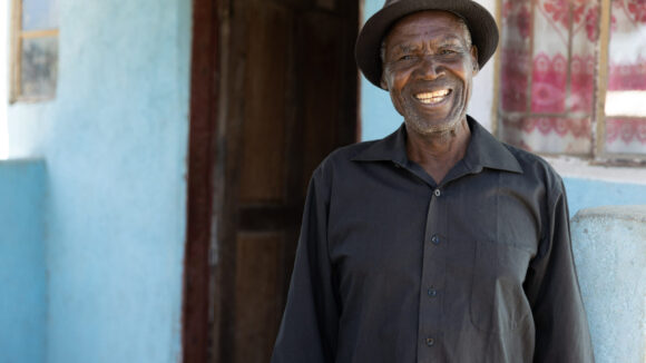 A man from Chinsali, Zambia smiles broadly.