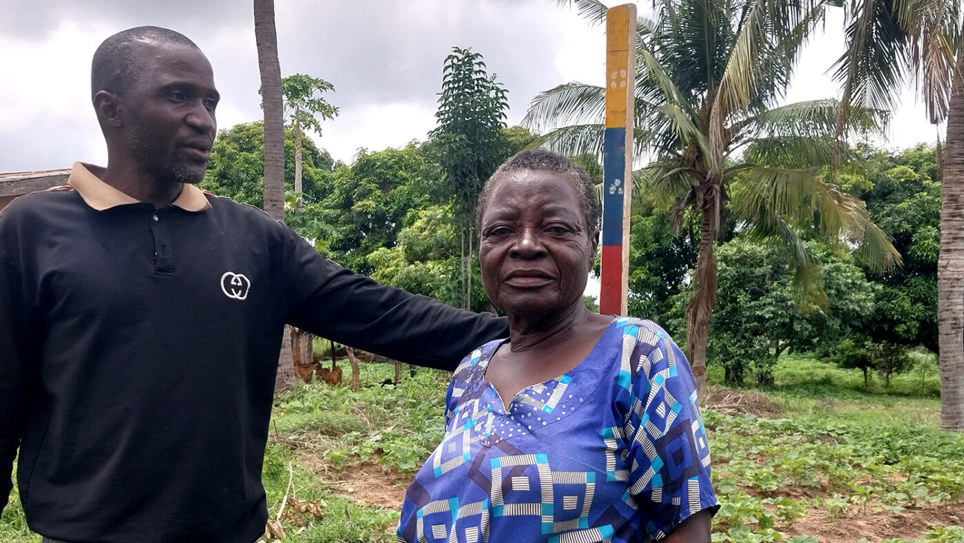 Volunteer Moses measures a woman's height to see how much medication she needs to protect her from river blindness.