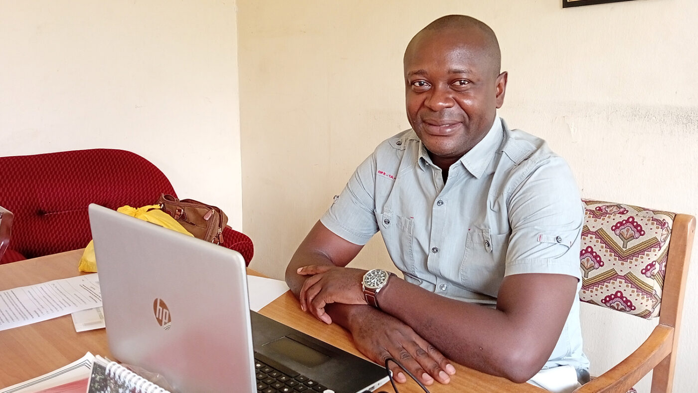 Terhemba, NTD coordinator for Benue's Ministry of Health, sits at his desk.