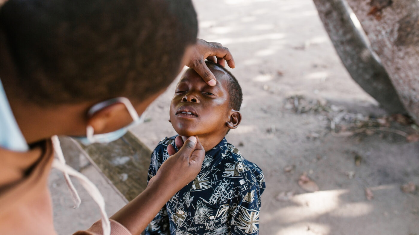 Mohamed has his eyes examined outdoors