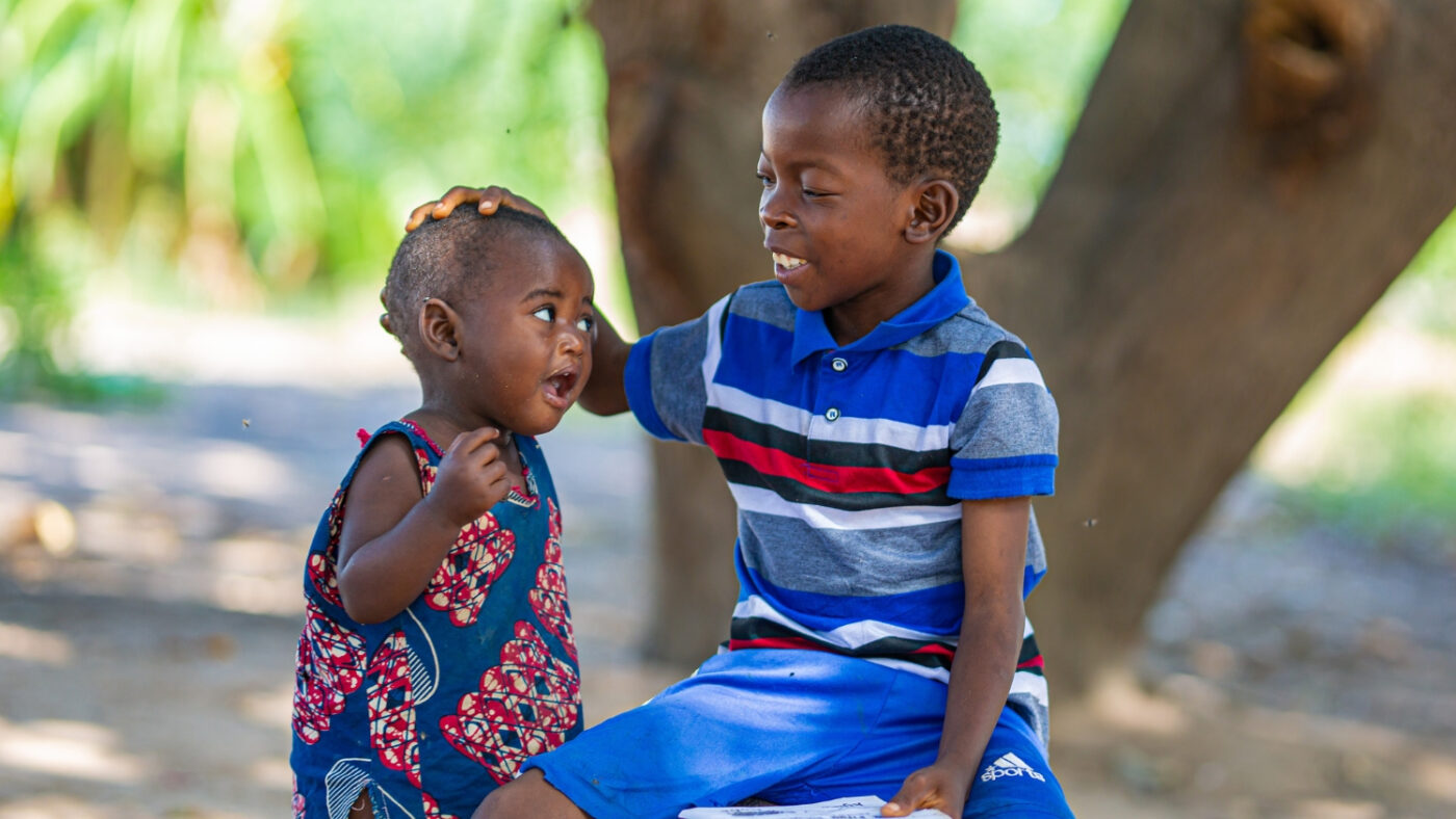 Mohamed plays outside with other children.