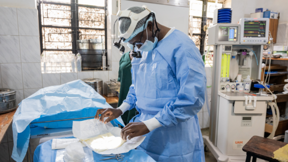 Surgeon Dr Benjamin Adina prepares equipment before a trachoma operation in a hospital in Uganda.